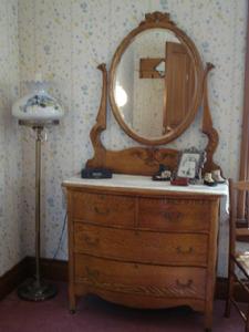 Antique oak dresser adorned with antique baby shoes